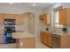 Lovely kitchen with wood cabinetry and tiled floors at 45113 W Buckhorn Trl, Maricopa, AZ 85139