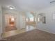 Spacious living room with neutral paint, tile flooring, and arched openings to other living spaces at 45113 W Buckhorn Trl, Maricopa, AZ 85139