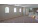 The carpeted loft area features architectural windows that provide natural light at 45113 W Buckhorn Trl, Maricopa, AZ 85139