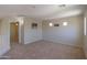 This carpeted loft includes unique window designs and a view of the downstairs at 45113 W Buckhorn Trl, Maricopa, AZ 85139