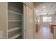 Walk-in pantry with ample shelving for organized storage, located off of kitchen at 45113 W Buckhorn Trl, Maricopa, AZ 85139