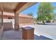Covered patio with tiled floors and a view of the backyard, offering a relaxing outdoor space at 45113 W Buckhorn Trl, Maricopa, AZ 85139