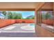 Outdoor view from under covered patio overlooking a beautiful private pool and backyard with hardscape at 45113 W Buckhorn Trl, Maricopa, AZ 85139