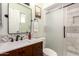 Bathroom vanity and tiled shower with glass doors at 4712 W Juniper Ave, Glendale, AZ 85306