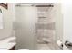 Modern bathroom with a white tiled shower and frosted glass door at 4712 W Juniper Ave, Glendale, AZ 85306