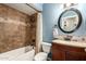 Full bathroom featuring a tub, shower, vanity and round mirror at 4712 W Juniper Ave, Glendale, AZ 85306