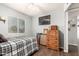 This bedroom includes a window, wood floors, a ceiling fan and neutral paint at 4712 W Juniper Ave, Glendale, AZ 85306
