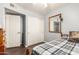 Comfortable bedroom featuring light walls, wood floors, and a sliding door closet at 4712 W Juniper Ave, Glendale, AZ 85306