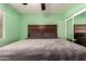 Bedroom featuring neutral walls, comfortable bed, and sliding mirror closet doors at 4712 W Juniper Ave, Glendale, AZ 85306