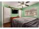 Comfortable bedroom featuring a ceiling fan and bright natural lighting at 4712 W Juniper Ave, Glendale, AZ 85306