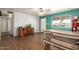 Inviting dining room with wood floors, a rustic table with benches, ceiling fan, and stylish decor at 4712 W Juniper Ave, Glendale, AZ 85306