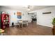 Inviting dining room with wood floors, a rustic table with benches, ceiling fan, and stylish decor at 4712 W Juniper Ave, Glendale, AZ 85306