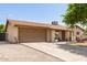 Single-story home with a two-car garage and driveway, partially xeriscaped front yard, and tidy landscaping at 4712 W Juniper Ave, Glendale, AZ 85306
