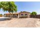 Single-story home with a two-car garage and driveway, partially xeriscaped front yard, and tidy landscaping at 4712 W Juniper Ave, Glendale, AZ 85306