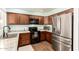 Well-equipped kitchen featuring stainless steel refrigerator and ample cabinet space at 4712 W Juniper Ave, Glendale, AZ 85306