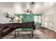 Cozy living room area with a large sectional sofa, ceiling fan, and natural lighting at 4712 W Juniper Ave, Glendale, AZ 85306