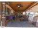 Comfortable outdoor space with covered patio, seating, and overhead fan at 4712 W Juniper Ave, Glendale, AZ 85306