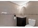 Well-lit bathroom with elegant vanity, decorative mirror and beautiful tilework at 4918 N 74Th St, Scottsdale, AZ 85251