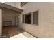 Covered front patio with tile flooring, window and exterior light fixture on stucco wall at 4918 N 74Th St, Scottsdale, AZ 85251