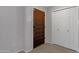Inviting front entryway featuring a decorative wood door, white closet and neutral walls at 4918 N 74Th St, Scottsdale, AZ 85251