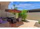 Cozy patio with stylish furniture, shade umbrella, and a landscaped view at 4918 N 74Th St, Scottsdale, AZ 85251