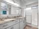 Bathroom features granite counters, white cabinets, shower, and large mirror at 5125 E Juana Ct, Cave Creek, AZ 85331