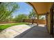 Backyard features a covered patio with shade from mature trees and synthetic grass at 5125 E Juana Ct, Cave Creek, AZ 85331