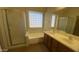 Bathroom showcasing a soaking tub, dual sinks, and a separate shower stall at 5374 N Ormondo Way, Litchfield Park, AZ 85340