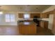 Functional kitchen featuring tile flooring, wooden cabinetry, and a convenient center island at 5374 N Ormondo Way, Litchfield Park, AZ 85340