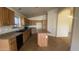 Well-equipped kitchen with wooden cabinets, tile floors, and a central island at 5374 N Ormondo Way, Litchfield Park, AZ 85340