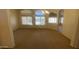 Spacious living room with carpet floors and multiple windows for natural light at 5374 N Ormondo Way, Litchfield Park, AZ 85340
