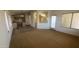 Open living area leading to the kitchen with a combination of carpet and tile flooring at 5374 N Ormondo Way, Litchfield Park, AZ 85340