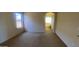 Relaxing bedroom featuring carpet flooring and an arched entrance to the bathroom at 5374 N Ormondo Way, Litchfield Park, AZ 85340