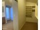 Spacious walk-in closet providing ample storage with built in shelving at 5374 N Ormondo Way, Litchfield Park, AZ 85340