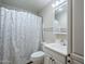 Standard bathroom with a single sink vanity, toilet, tub, and a shower curtain with colored dots at 5618 E Des Moines St, Mesa, AZ 85205