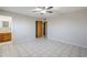 Well-lit bedroom featuring tile flooring, a modern ceiling fan, and access to an ensuite bathroom with sink at 5618 E Des Moines St, Mesa, AZ 85205