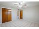 A neutral bedroom featuring tile floors, a ceiling fan, and closet at 5618 E Des Moines St, Mesa, AZ 85205