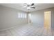Bedroom featuring tile flooring, a ceiling fan, and a closet for an organized and comfortable space at 5618 E Des Moines St, Mesa, AZ 85205