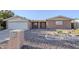 Charming single-story home with brick facade, desert landscaping, and attached two-car garage at 5618 E Des Moines St, Mesa, AZ 85205