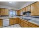 Well-lit kitchen features tile countertops and backsplash, and ample wooden cabinetry at 5618 E Des Moines St, Mesa, AZ 85205