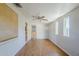 Bright, airy living room featuring wood flooring, ample natural lighting, and a ceiling fan for added comfort at 5618 E Des Moines St, Mesa, AZ 85205