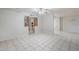 Bright living room features tile floors, ceiling fan, and decorative partition at 5618 E Des Moines St, Mesa, AZ 85205