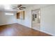 Spacious living room featuring stylish wood flooring, a ceiling fan, and a built-in display case at 5618 E Des Moines St, Mesa, AZ 85205