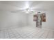 Spacious living room features tile flooring, ceiling fan, and decorative partition detail at 5618 E Des Moines St, Mesa, AZ 85205