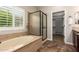 Bathroom featuring a soaking tub, shower, and walk-in closet at 595 W Dragon Tree Ave, Queen Creek, AZ 85140