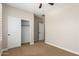 A well-lit bedroom with a closet and view to the hall at 595 W Dragon Tree Ave, Queen Creek, AZ 85140