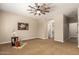 Spacious bedroom with neutral walls and carpet, with an adjacent room and closet at 595 W Dragon Tree Ave, Queen Creek, AZ 85140