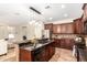 Open kitchen with stainless steel appliances, granite countertops, and a breakfast bar at 595 W Dragon Tree Ave, Queen Creek, AZ 85140