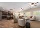 Spacious living area featuring tile floors, ceiling fans, and plantation shutters at 595 W Dragon Tree Ave, Queen Creek, AZ 85140