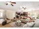 Open living room with ceiling fans and a view into the kitchen at 595 W Dragon Tree Ave, Queen Creek, AZ 85140